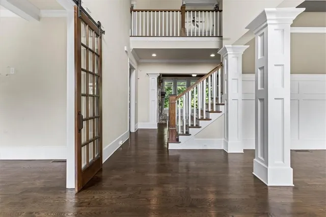a view of entryway with wooden floor and stairs