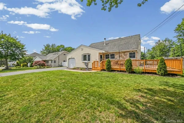 a view of a house with backyard and sitting area