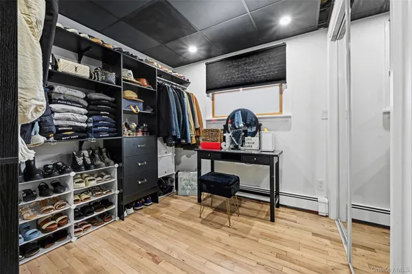 a view of walk in closet with clothes and shoes