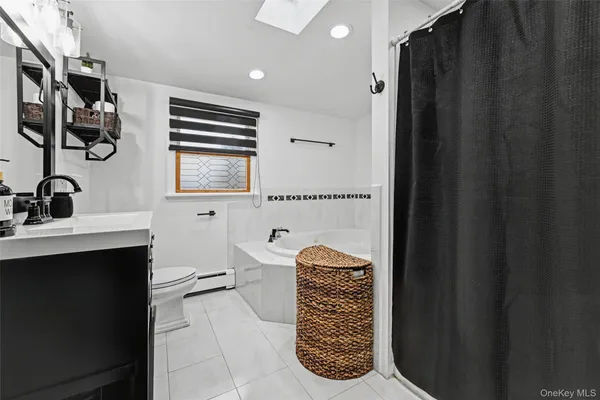 a bathroom with a sink a toilet and a shower