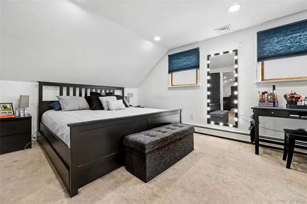 a bedroom with a bed and a couch