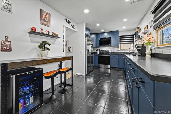 a kitchen with stainless steel appliances granite countertop a refrigerator and a stove top oven