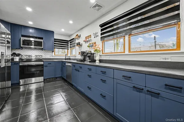 a kitchen with stainless steel appliances granite countertop a sink and cabinets