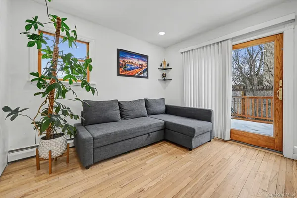 a living room with furniture and a potted plant