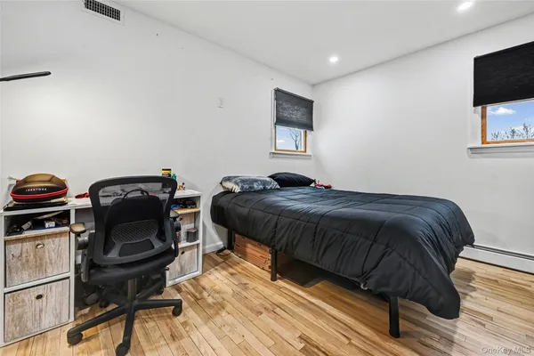 a bedroom with a bed and a tv