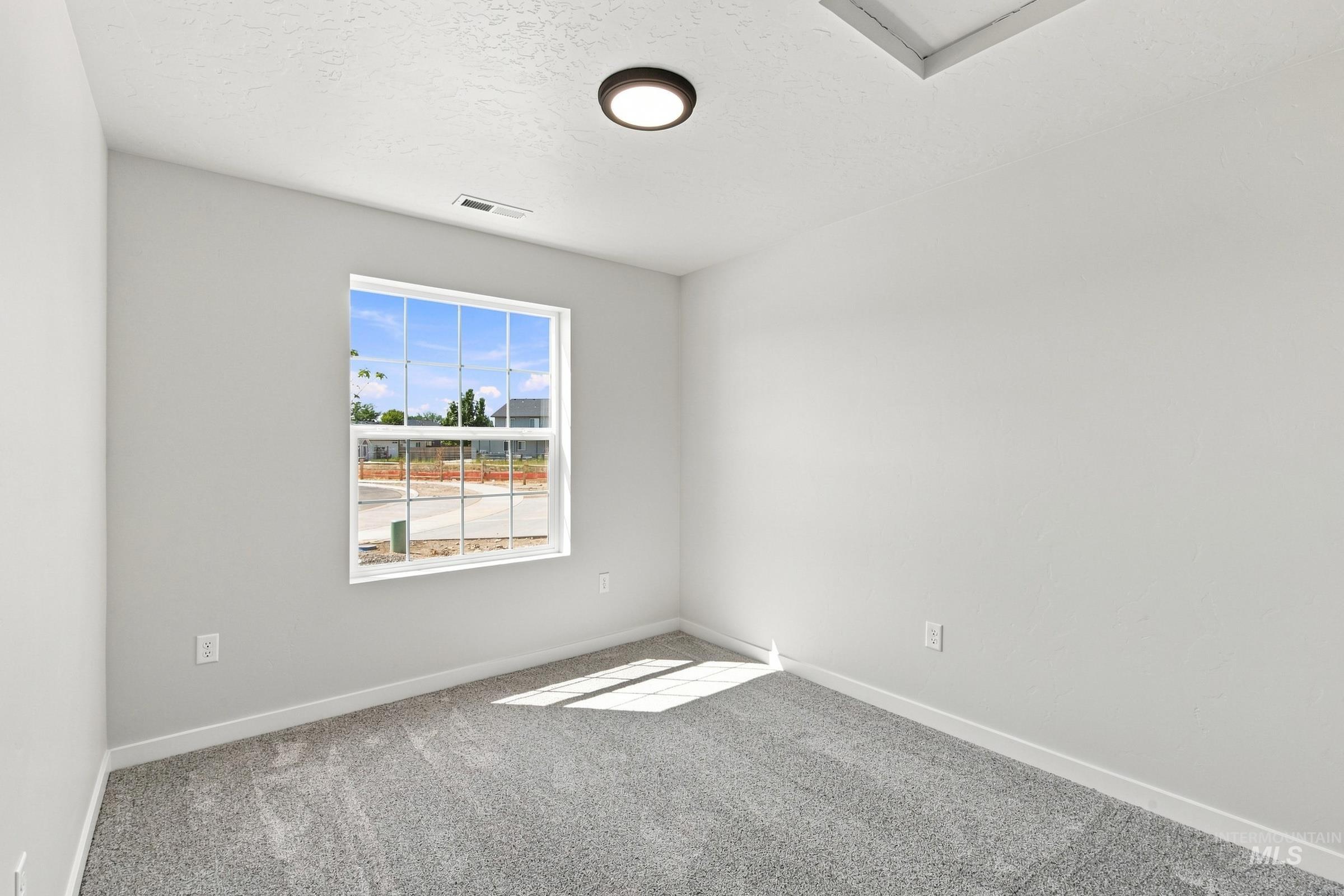 464 Merlin Court Middleton, ID 83644 - Photo 11 of 26 Window with grid muntins, recessed lighting, and grey carpeting