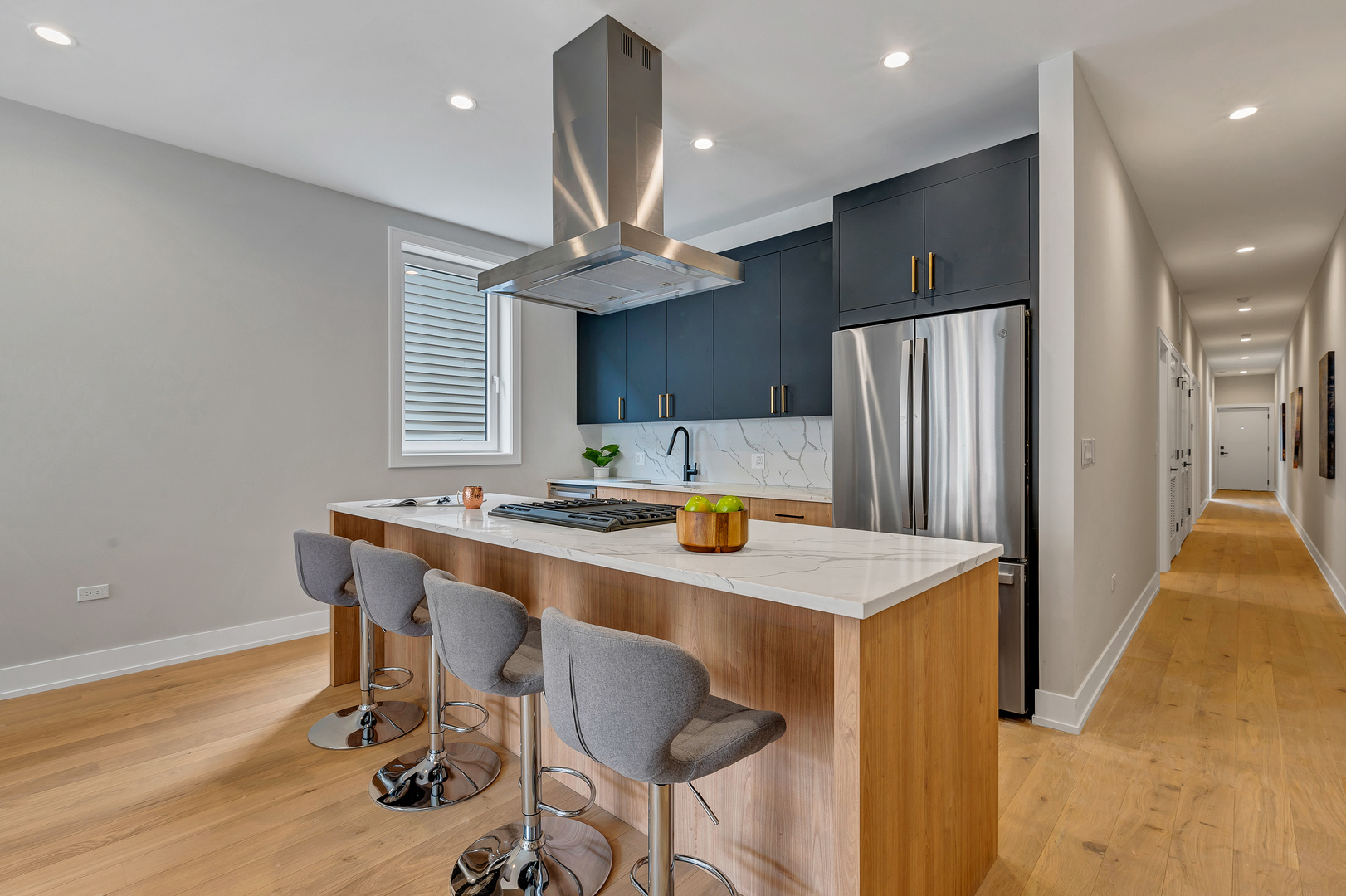 2341 West Adams Street, Unit 4W Chicago, IL 60612 - Photo 5 of 15 a kitchen with stainless steel appliances a dining table chairs and wooden floor