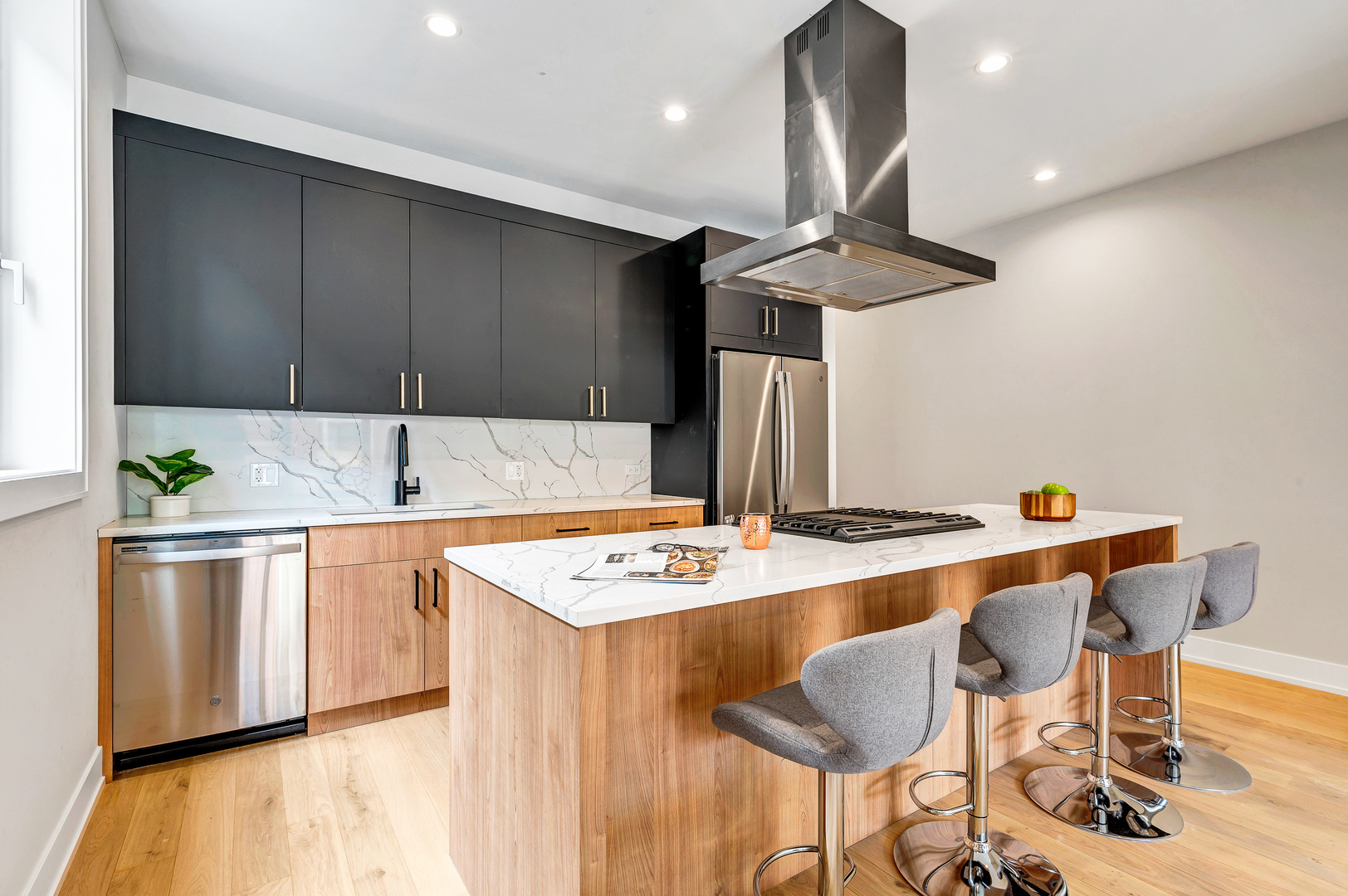 2341 West Adams Street, Unit 4W Chicago, IL 60612 - Photo 6 of 15 a kitchen with stainless steel appliances granite countertop a sink a stove a refrigerator a microwave oven with white cabinets and wooden floor