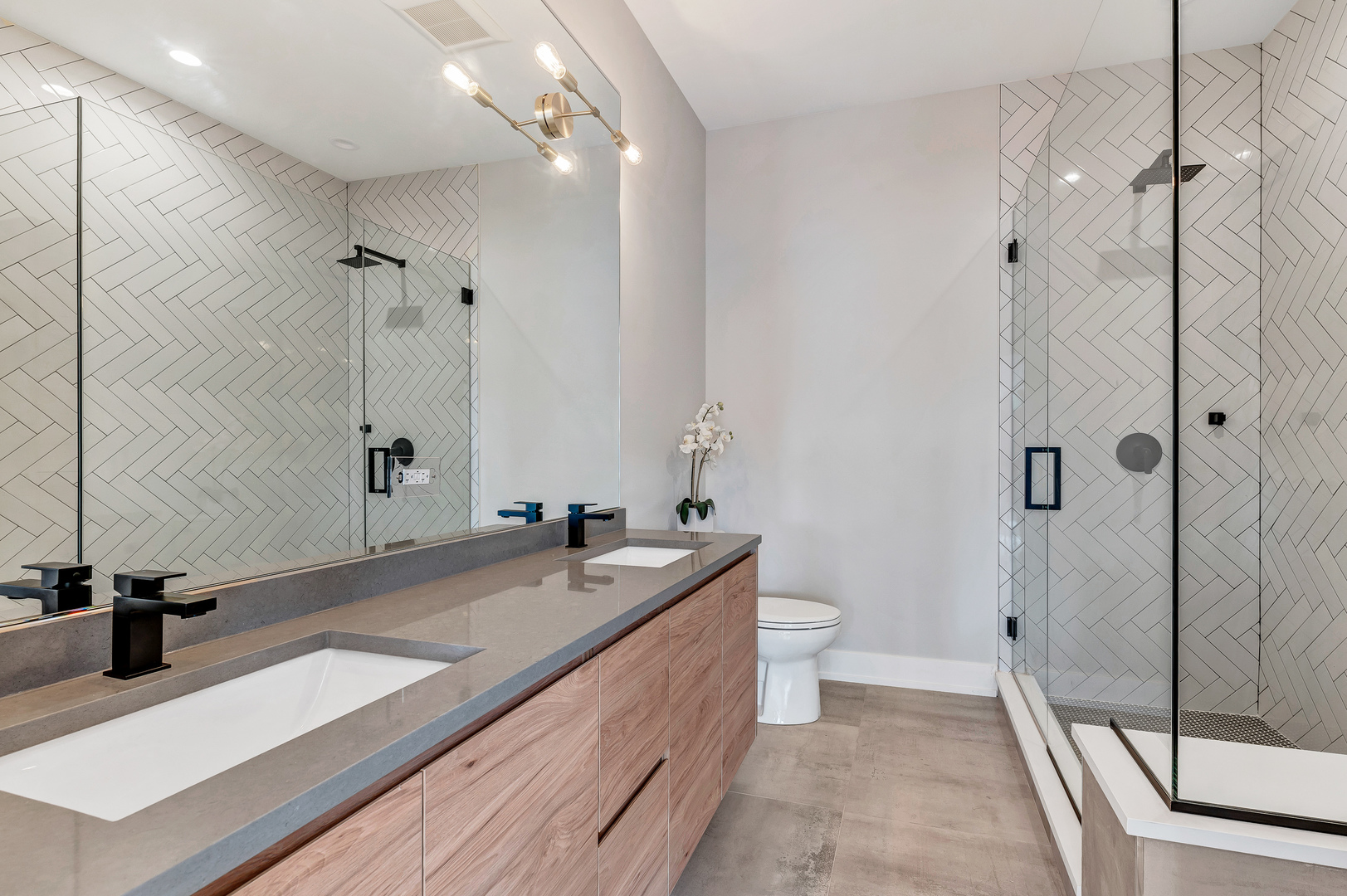 2341 West Adams Street, Unit 4W Chicago, IL 60612 - Photo 8 of 15 a spacious bathroom with a double vanity sink a toilet and a mirror