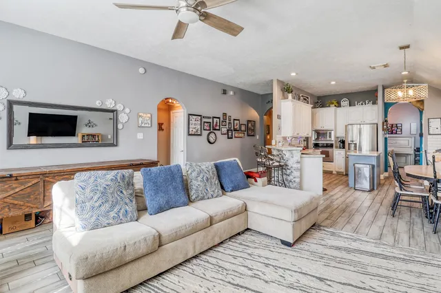 a living room with furniture and kitchen view