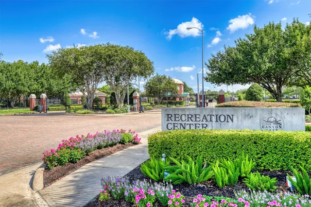 a view of sign board with flower around