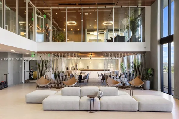 a dining room with furniture and a potted plant