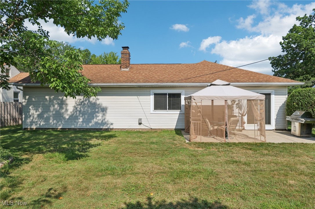 5877 Pearl Road Cleveland, OH 44130 - Photo 38 of 42 Rear view of property featuring a shingled roof, a chimney, and a patio area