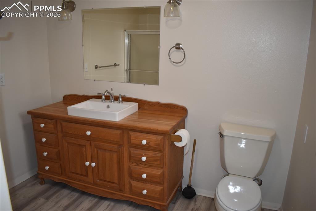 805 Raton Avenue La Junta, CO 81050 - Photo 11 of 26 a bathroom with a sink vanity and mirror