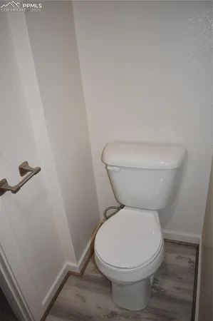 a white toilet sitting next to a sink