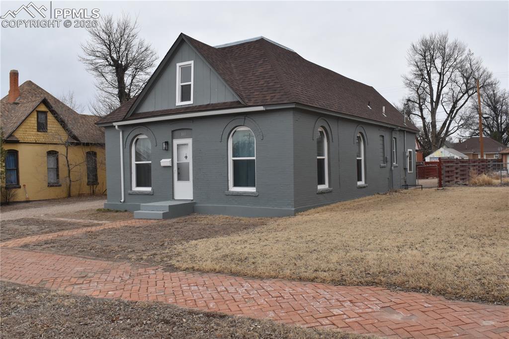 805 Raton Avenue La Junta, CO 81050 - Photo 2 of 26 a front view of a house with a yard and garage