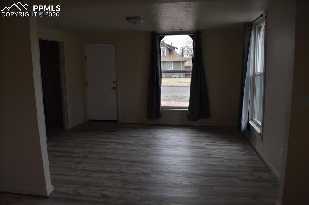 805 Raton Avenue La Junta, CO 81050 - Photo 26 of 26 an empty room with wooden floor and windows