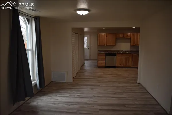 a large kitchen with stainless steel appliances a large counter top a stove and a refrigerator