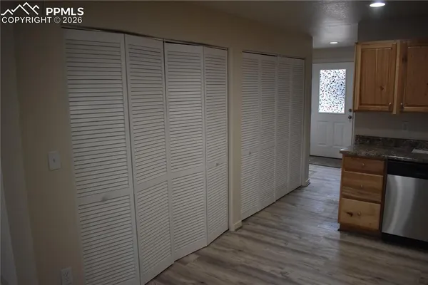 a kitchen with stainless steel appliances wooden floor and mountain view