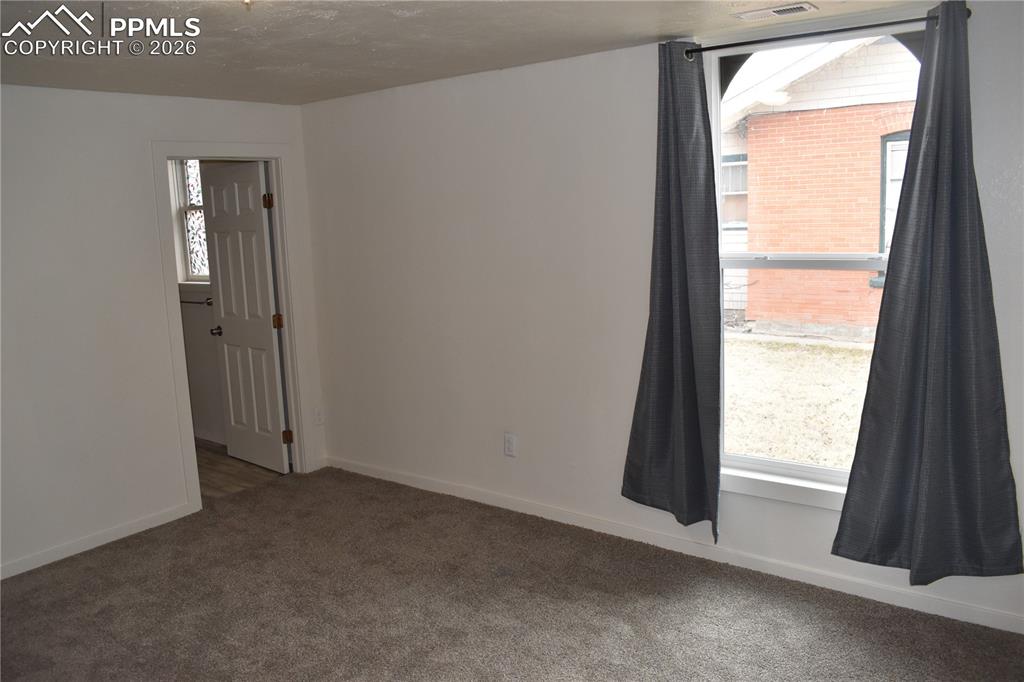805 Raton Avenue La Junta, CO 81050 - Photo 9 of 26 an empty room with windows