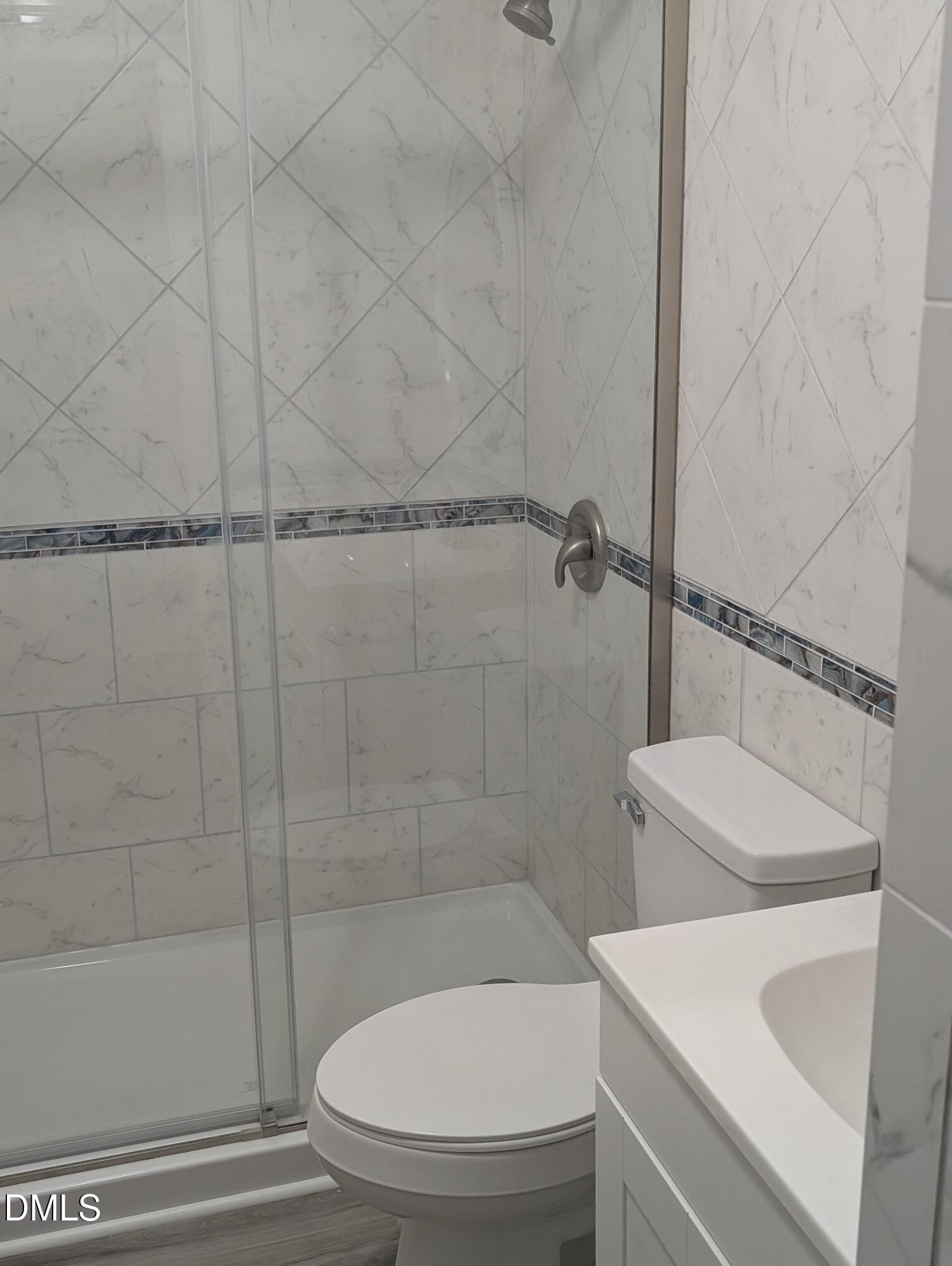 1005 Shades Place Raleigh, NC 27601 - Photo 15 of 18 a bathroom with a sink a toilet and shower