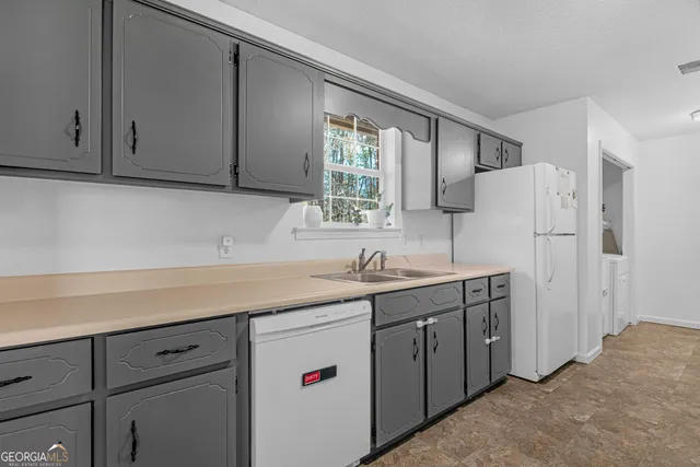 a kitchen with a sink cabinets and window