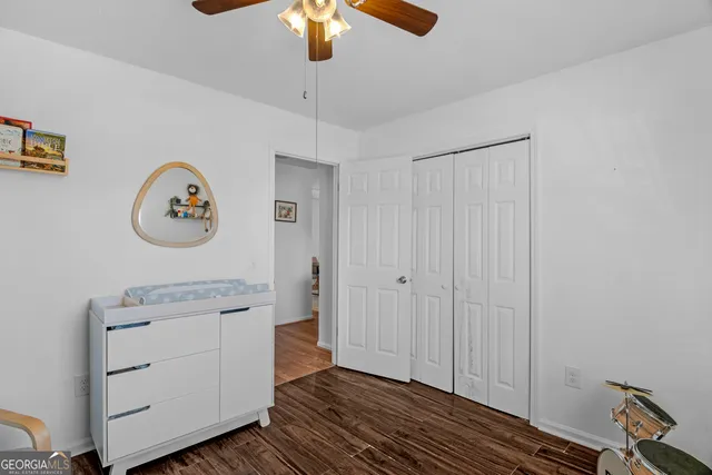 a view of a hallway with entryway wooden floor and cabinet