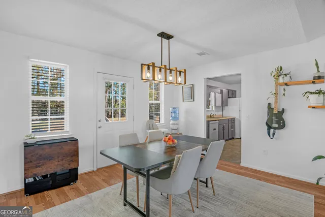 a view of a dining room with furniture window and wooden floor