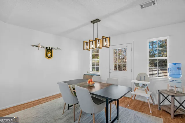 a view of a dining room with furniture window and outside view