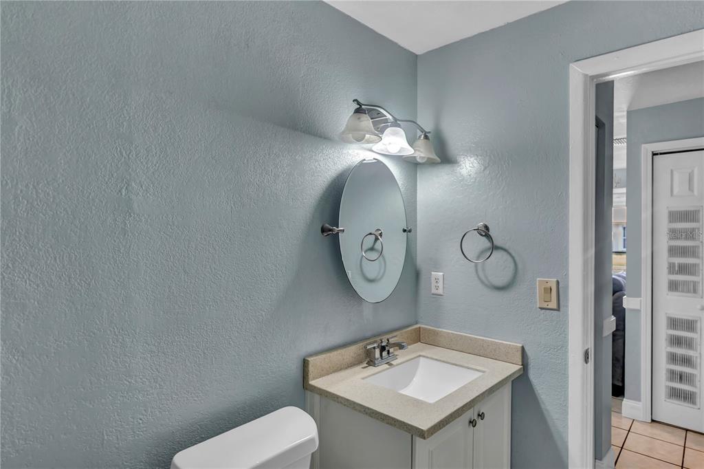 3117 Ludlow Drive New Port Richey, FL 34655 - Photo 16 of 20 a bathroom with a toilet a sink and a mirror