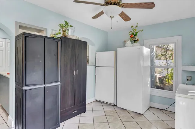 a kitchen with stainless steel appliances a refrigerator and ceiling fan