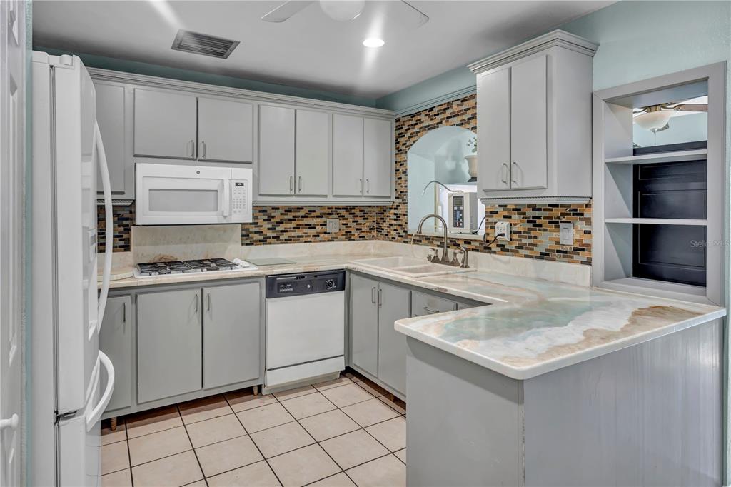 3117 Ludlow Drive New Port Richey, FL 34655 - Photo 2 of 20 a kitchen with sink cabinets and stove