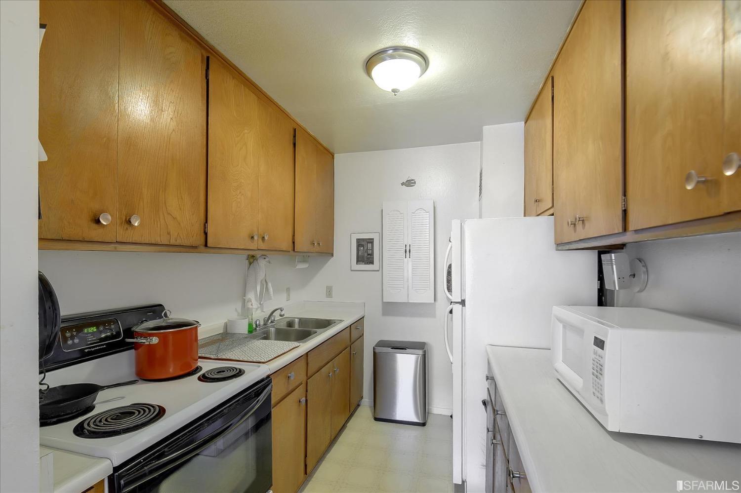 50 Inca Lane, Unit 5 San Francisco, CA 94115 - Photo 8 of 33 a kitchen with stainless steel appliances stove refrigerator sink and cabinets