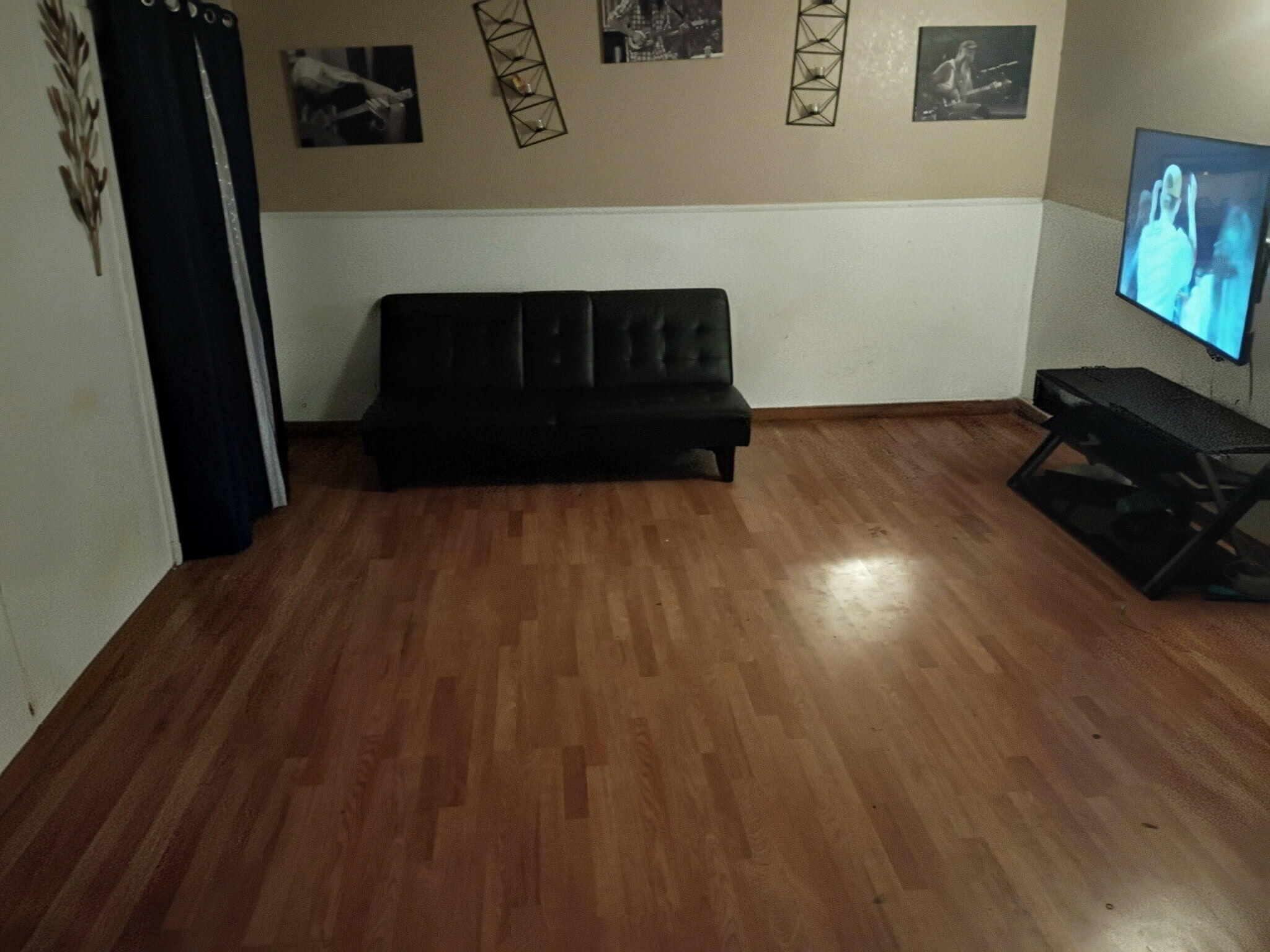 2304 48th Street Lubbock, TX 79412 - Photo 3 of 5 a living room with wooden floor and a fireplace