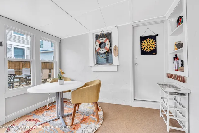 a view of a room that has a table and chairs in it