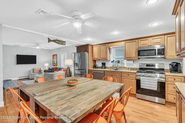 a kitchen with stainless steel appliances granite countertop a stove refrigerator and cabinets