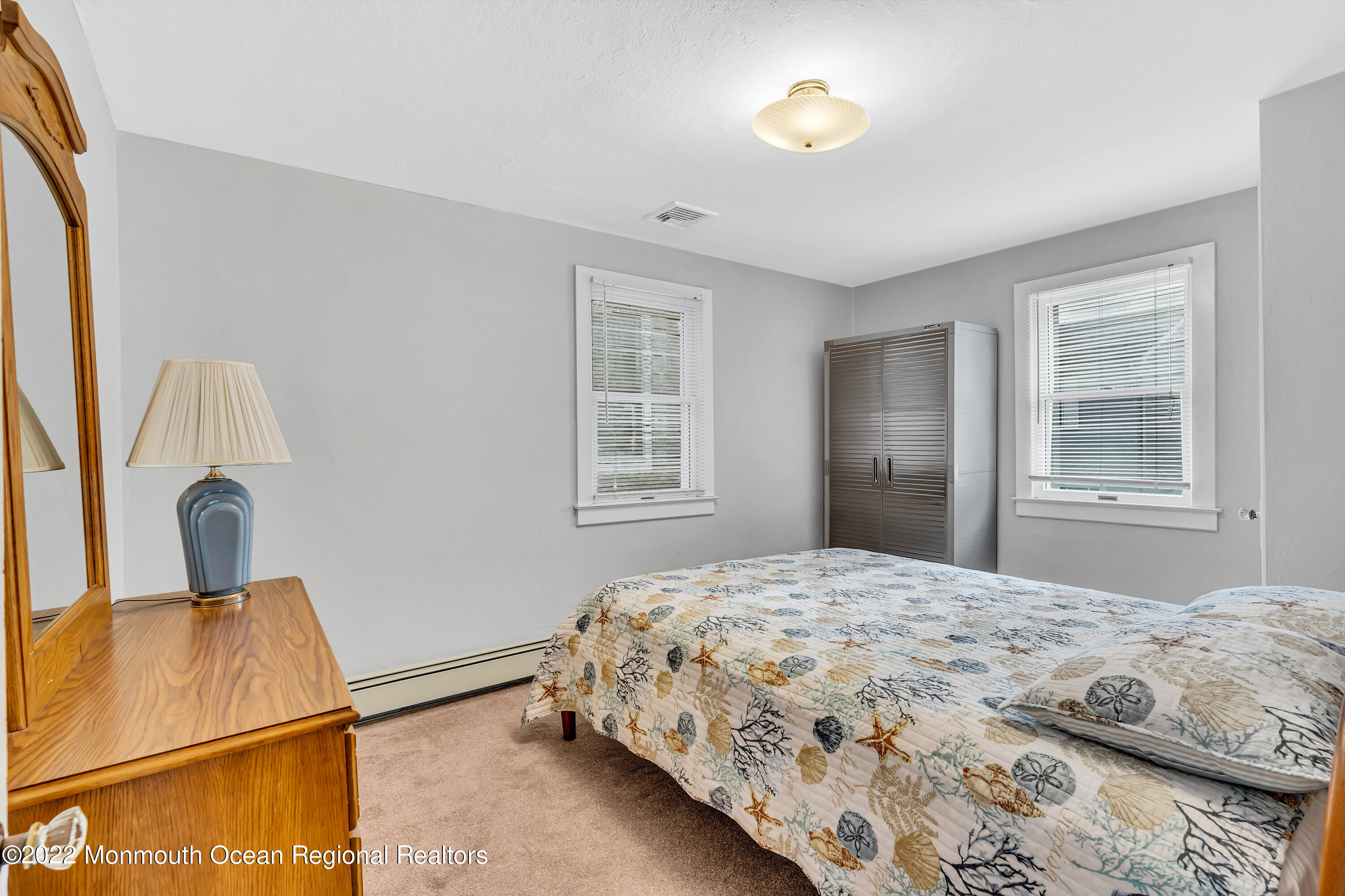 57 Fielder Avenue Seaside Heights, NJ 08751 - Photo 26 of 31 a bedroom with a bed and a dresser with mirror
