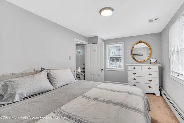 a bedroom with a bed a closet and large mirror