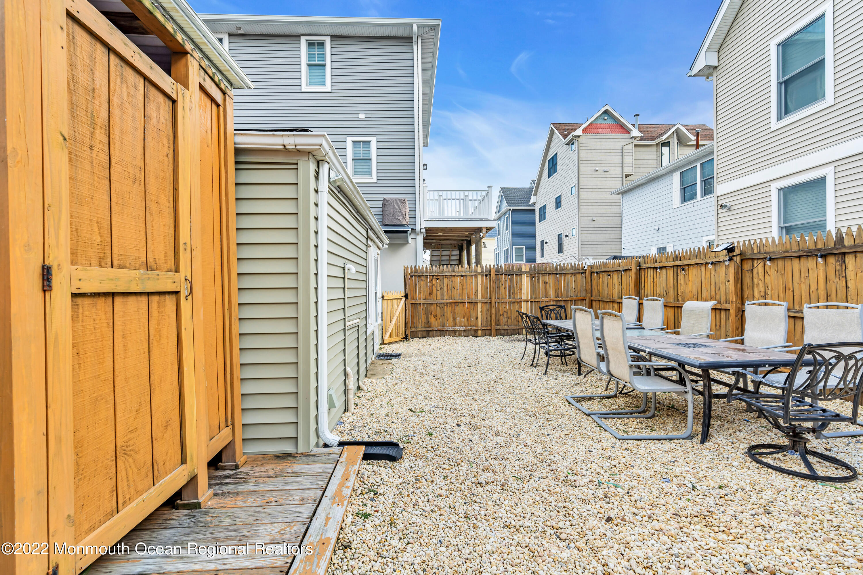 57 Fielder Avenue Seaside Heights, NJ 08751 - Photo 31 of 31 a view of a patio with a table and chairs and wooden floor