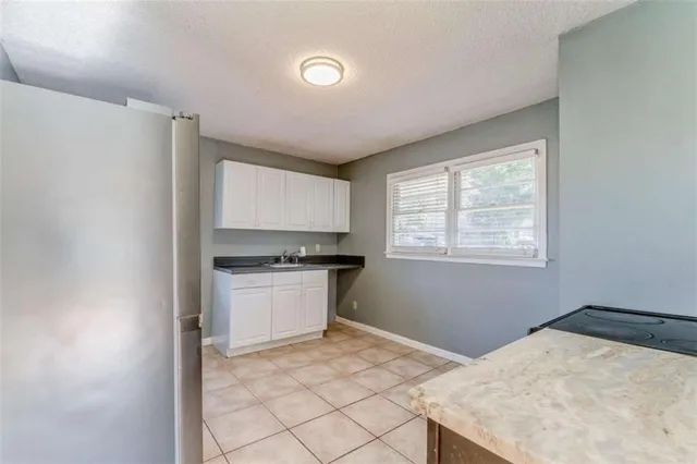 a kitchen with a stove cabinets and a refrigerator