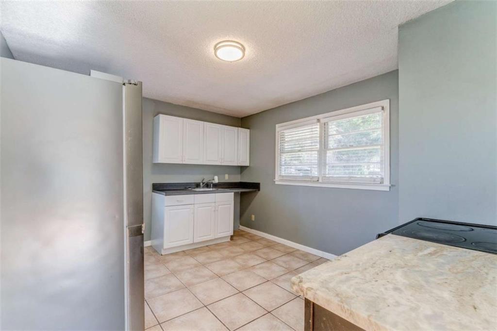 1407 East 2nd Avenue Southeast Rome, GA 30161 - Photo 12 of 28 a kitchen with a stove cabinets and a refrigerator
