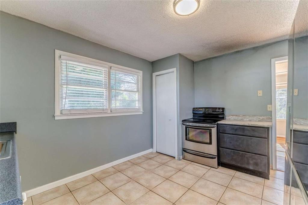 1407 East 2nd Avenue Southeast Rome, GA 30161 - Photo 13 of 28 a kitchen with stainless steel appliances granite countertop a stove and a refrigerator