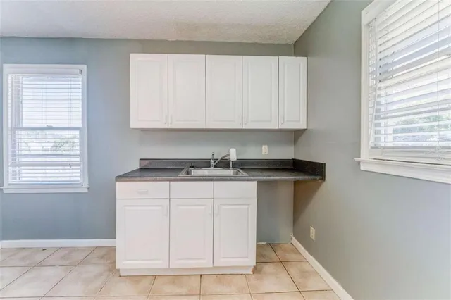 a kitchen with a sink cabinets and window