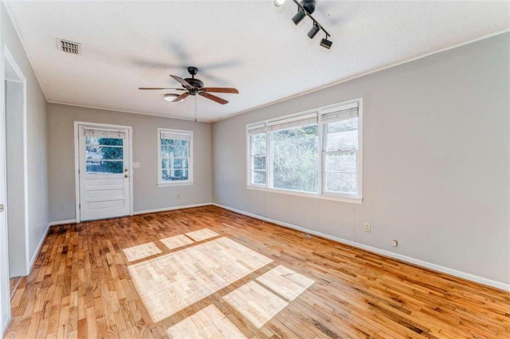 1407 East 2nd Avenue Southeast Rome, GA 30161 - Photo 16 of 28 a view of a bedroom with wooden floor and a chandelier fan