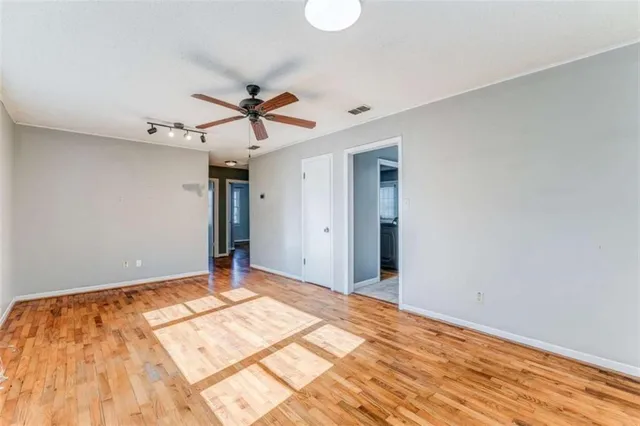 a view of a room with a ceiling fan