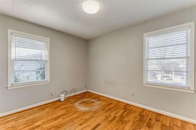 a view of a room with wooden floor and windows