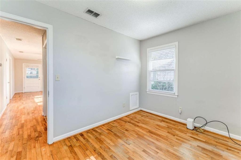 1407 East 2nd Avenue Southeast Rome, GA 30161 - Photo 3 of 28 a view of empty room with wooden floor and fan