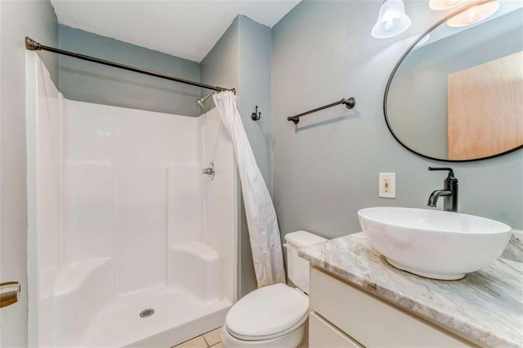 1407 East 2nd Avenue Southeast Rome, GA 30161 - Photo 6 of 28 a bathroom with a sink a toilet and a mirror