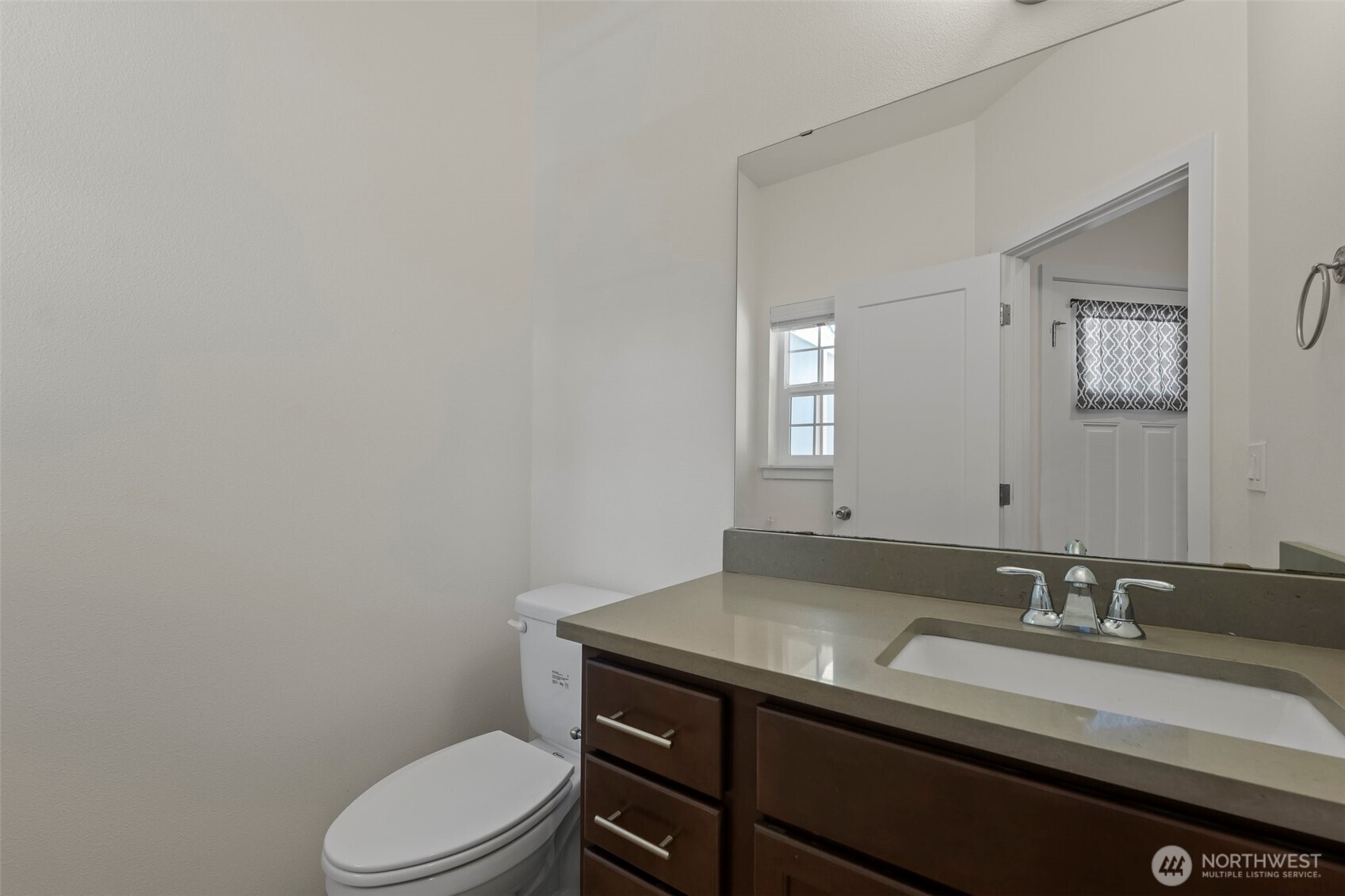 1080 East Old Ranch Road, Unit A1A2 Allyn, WA 98524 - Photo 9 of 35 a bathroom with a granite countertop sink mirror vanity and toilet