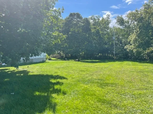 a swimming pool with outdoor seating and yard